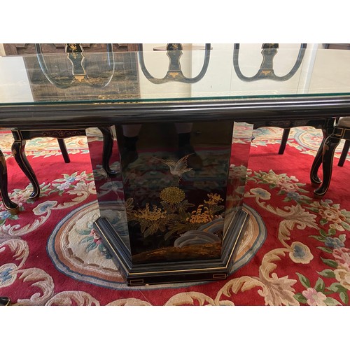 20 - A reproduction black Chinoiserie decorated dining table with extra centre leaf, the top decorated wi... 