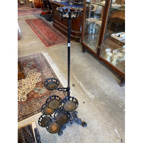 43 - A cast iron eight tier candle holder, on shaped base