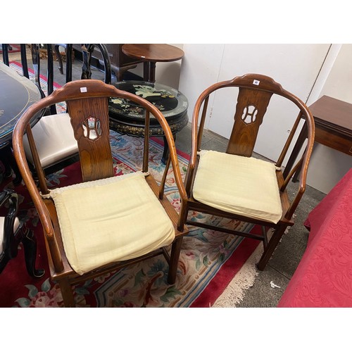 41 - A pair of American chairs in the Chinese style with curved backs, hard seats, on panelled legs