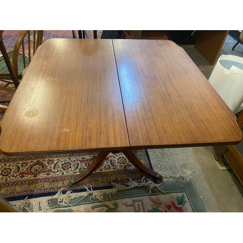 50 - A mahogany tea table with shaped rectangular top, urn form centre column, four reeded downswept legs... 