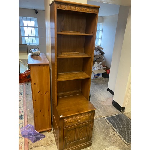 49 - An Ercol dark elm display cabinet, the upper part fitted three shelves, the base fitted drawer and c... 