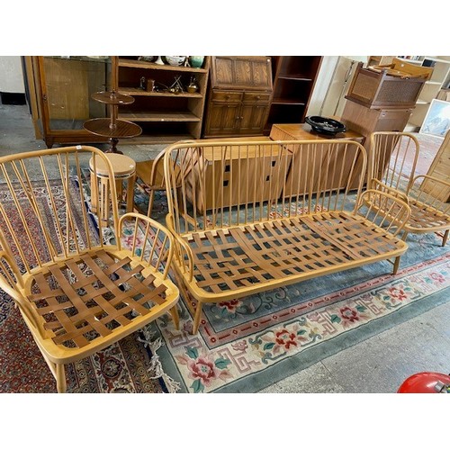 54 - An Ercol light elm settee suite comprising:- settee and pair of armchairs