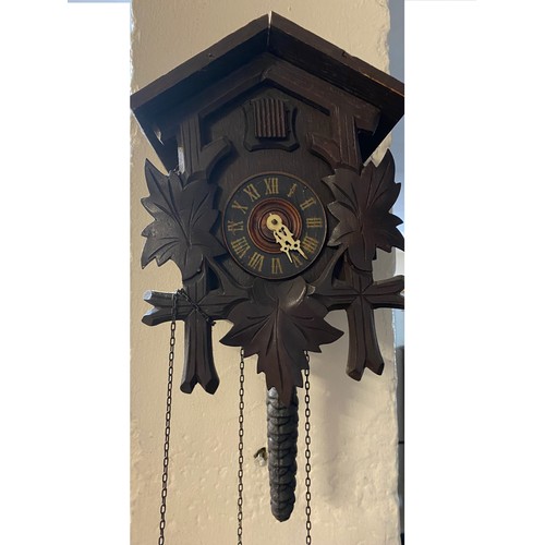 36 - A small wooden cuckoo clock with fir cone weights