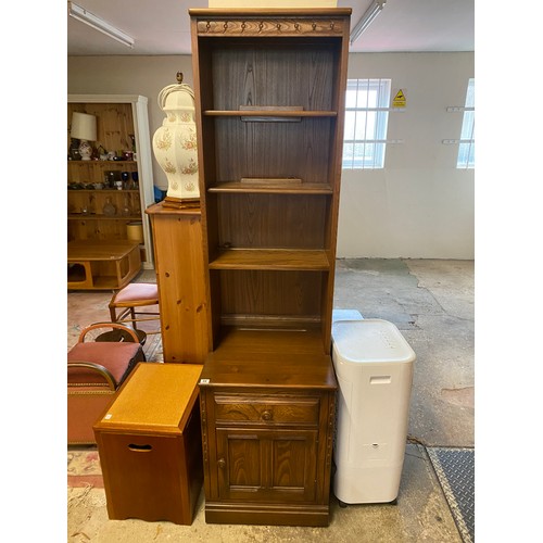 49 - An Ercol dark elm display cabinet, the upper part fitted three shelves, the base fitted drawer and c... 