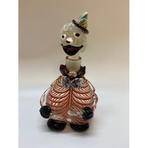 192 - A Murano decanter in the form of a clown with red and white striped body, multi coloured hat and bow... 