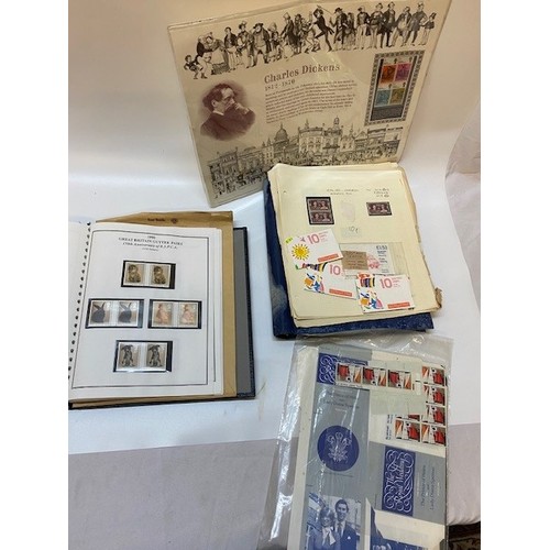 38 - An album of GB gutter pairs, a blue album of stamps, loose sheets of stamps etc..