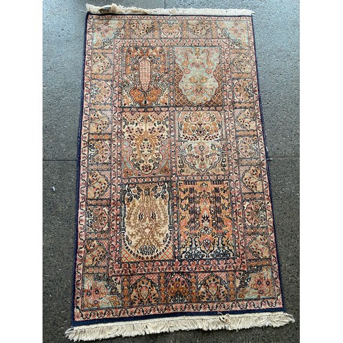 6 - A Persian rug, blue and red field with floral decoration - 75in. x 53in. and a Persian silk finished... 