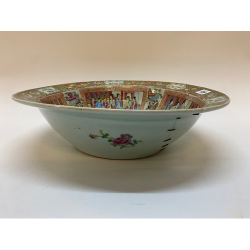 128 - A 19th Century Cantonese toilet bowl decorated in alternate reserves with figures in interiors, vase... 