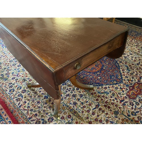 44 - A Georgian mahogany Pembroke table fitted two drop flaps, turned centre column and four acanthus lea... 