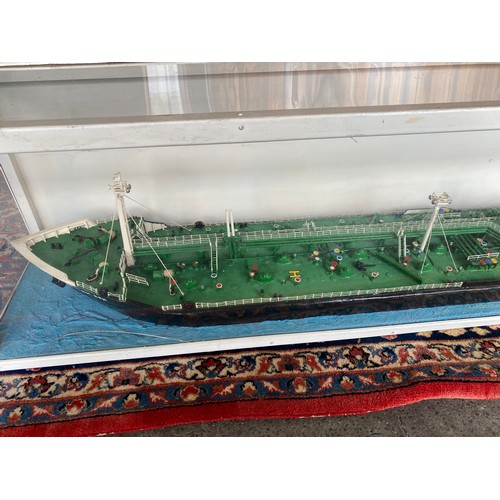 283 - A large painted wood model of the BP oil tanker British Esk of London, in display case - 72in. long