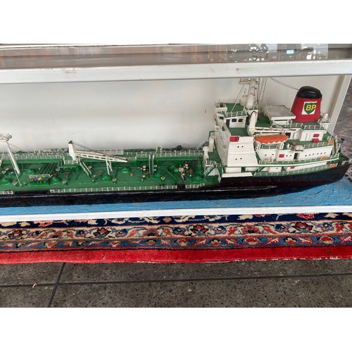 283 - A large painted wood model of the BP oil tanker British Esk of London, in display case - 72in. long