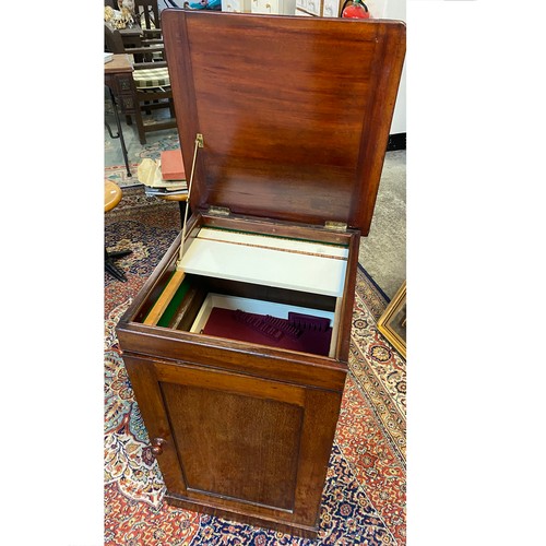 39 - A Victorian mahogany cupboard fitted hinged lid and panelled door stamped Holland and Son, on platfo... 