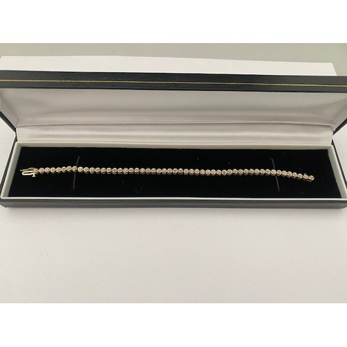 286 - A 9ct. gold line bracelet illusion set diamonds