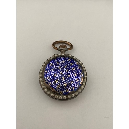 290 - A lady's openface fob watch with white enamel dial, blue numerals, in a white metal case decorated i... 