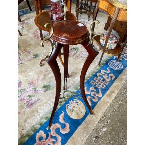 99 - A mahogany bowl stand on three downswept legs with brass feet and a reproduction mahogany torchere w... 