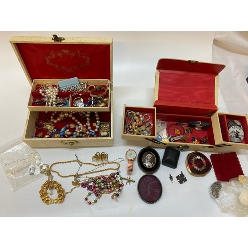 163 - A selection of costume jewellery contained in two cream jewellery boxes including necklaces, brooche... 