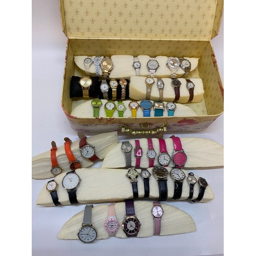 165 - A lilac floral decorated storage case containing a large quantity of dress watches, many on coloured... 