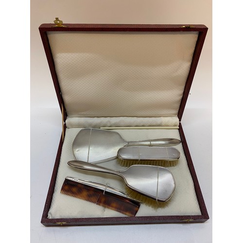 140 - A lady's three piece dressing table set with engine turned silver decoration and a comb with silver ... 