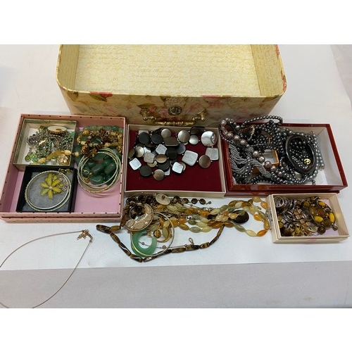 164 - A yellow floral decorated storage case containing a selection of costume jewellery including green p... 