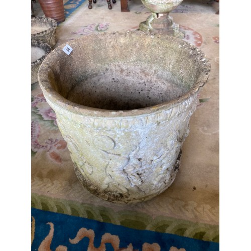 84 - A large concrete garden pot with raised decoration of putti and classical figures - 18in. high