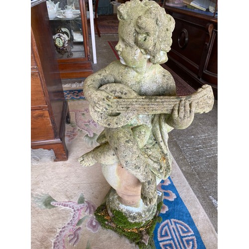 54 - A concrete model of a putto playing a mandolin, seated on an orb, on square base - 40 1/2in. high