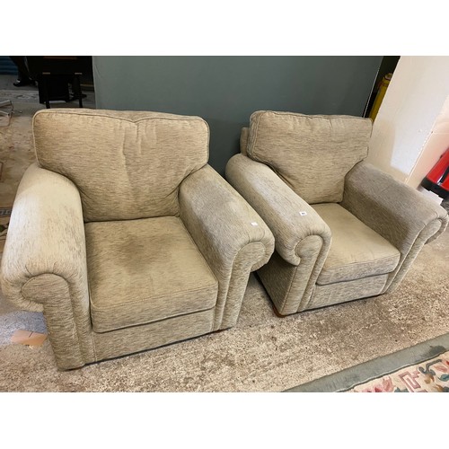 85 - A pair of modern armchairs with roll arms, loose seat cushions, upholstered in green material, on sh... 