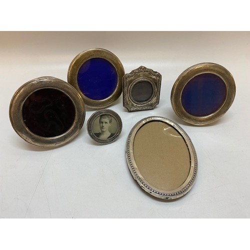 137 - Four circular photograph frames with silver fronts, an oval ditto and a shaped square ditto