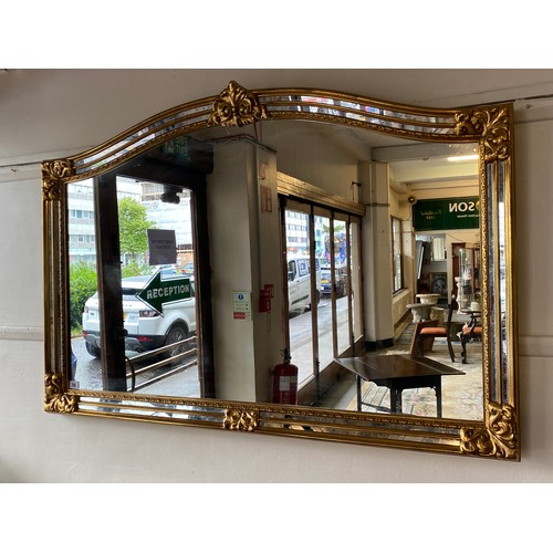 36 - A modern overmantel mirror in a gilt frame with mirrored border - 35in. x 51in.