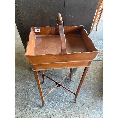 99 - An Edwardian mahogany sewing basket on stand fitted centre handle, on four slender legs with 'X' sha... 