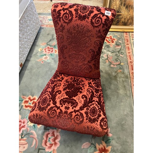 100 - A Victorian Prie Dieu chair upholstered in red floral decorated material, on turned legs terminating... 