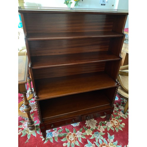 50 - A reproduction mahogany waterfall bookcase with pierced brass 3/4 gallery, fitted three open shelves... 