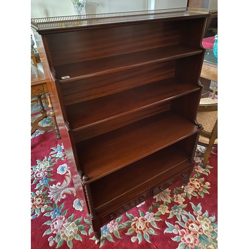 50 - A reproduction mahogany waterfall bookcase with pierced brass 3/4 gallery, fitted three open shelves... 