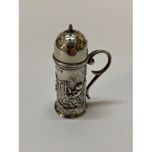 272 - A silver pepperette of tankard form with scroll handle and repousse decoration of figures - Birmingh... 