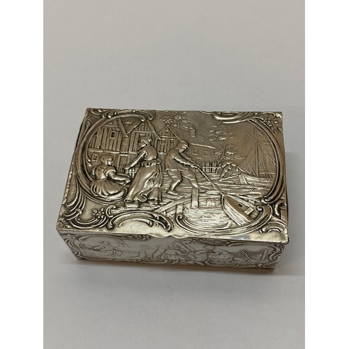 270 - A Continental silver box, the lid and sides with repousse decoration of figures within scroll border... 