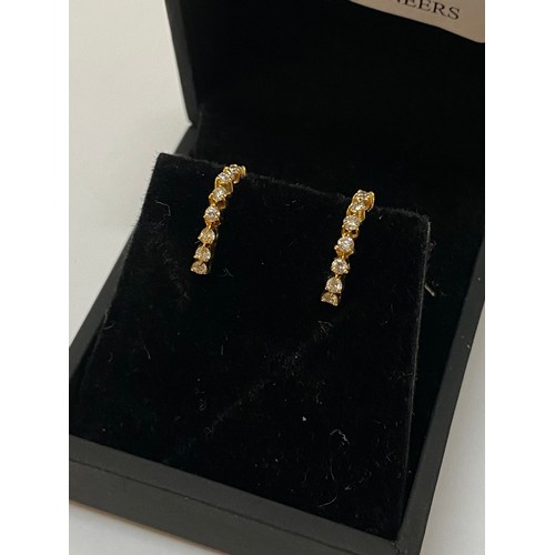 310 - A pair of 18ct. gold and diamond set hoop earrings with screw backs