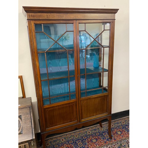 53 - An Edwardian mahogany and satinwood inlaid display cabinet, fitted two glass and panelled doors with... 