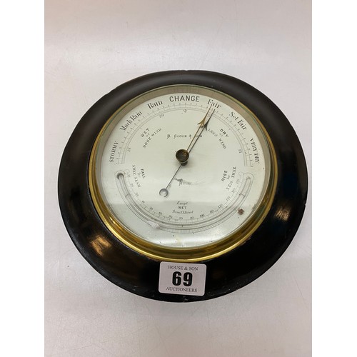 69 - An aneroid barometer by B Cooke and Son in an ebonised frame