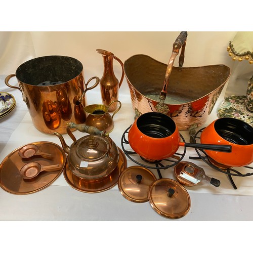 61 - A large copper coal bucket, on paw feet, a copper ewer, fondue set, copper double handled cooking po... 