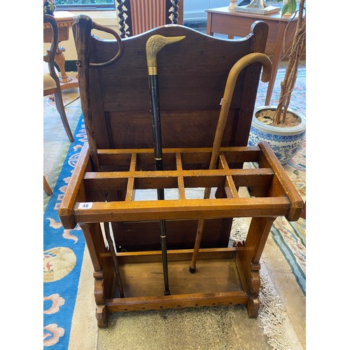 40 - A Victorian oak stickstand with ebony inlaid decoration - 24in. wide and three walking sticks