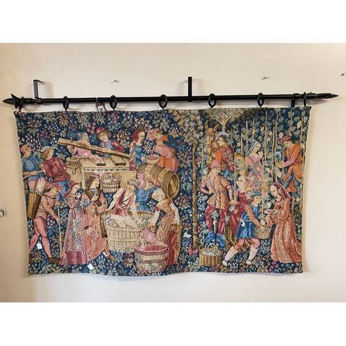 36 - A rectangular wall hanging machine made tapestry depicting Medieval figures, on metal pole - 46in. x... 