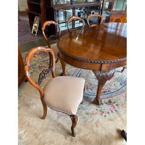 39 - A mahogany dining table with oval top, two extra centre leaves, on cabriole legs with claw and ball ... 