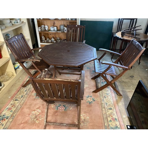 35 - A teak folding table and four folding chairs