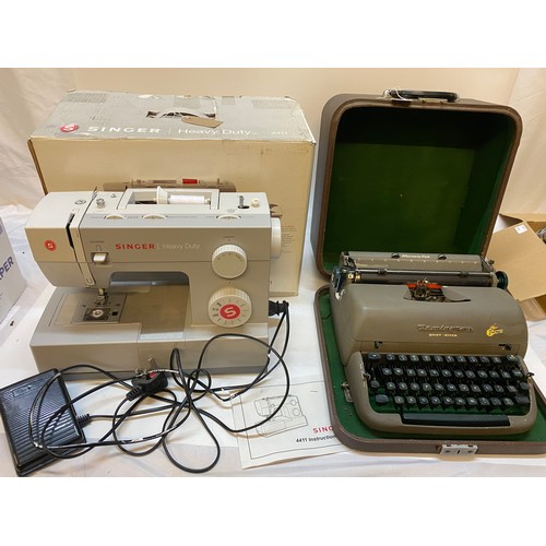 56 - A Singer sewing machine in fitted box and a Remington typewriter in original box