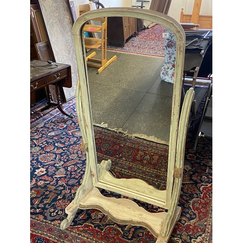 71 - A Victorian cheval mirror in a shabby chic cream painted scrolling frame, on shaped base and scroll ... 