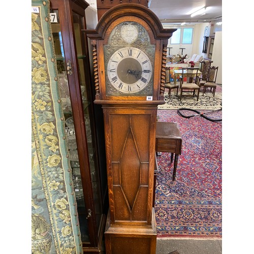 68 - A 1930's Synchronous electric chiming  grandmother clock in an oak case, the base fitted two doors e... 