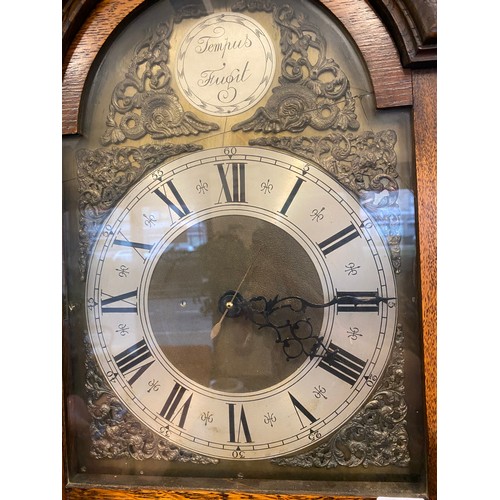 68 - A 1930's Synchronous electric chiming  grandmother clock in an oak case, the base fitted two doors e... 