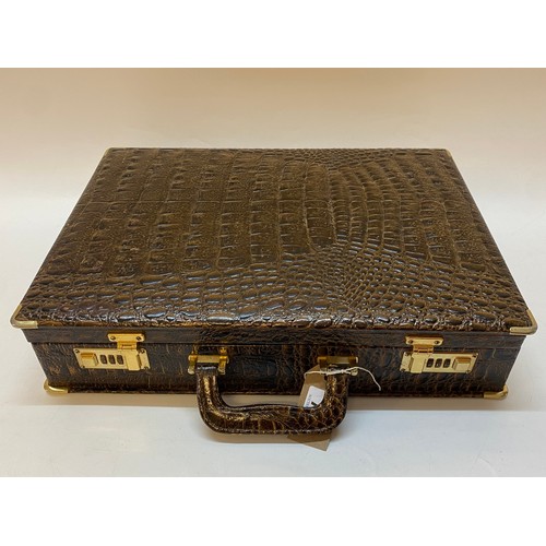 73 - A printed leather crocodile effect attache case with suede lining and document trays