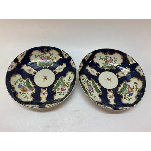 150 - A pair of late 18th Century Worcester porcelain dished plates, blue scale ground painted in reserves... 