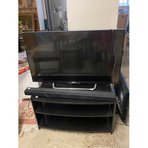 51 - A Sony Bravia 42in. television with Sony soundbar, speaker and stand