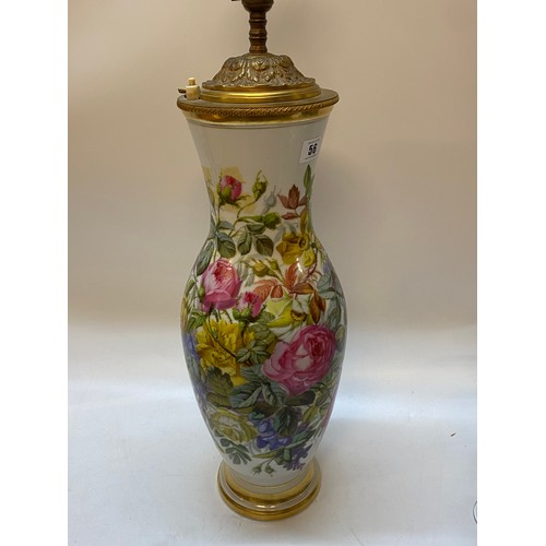 56 - A porcelain tablelamp base with floral decoration highlighted in gilding with brass mounts, complete... 